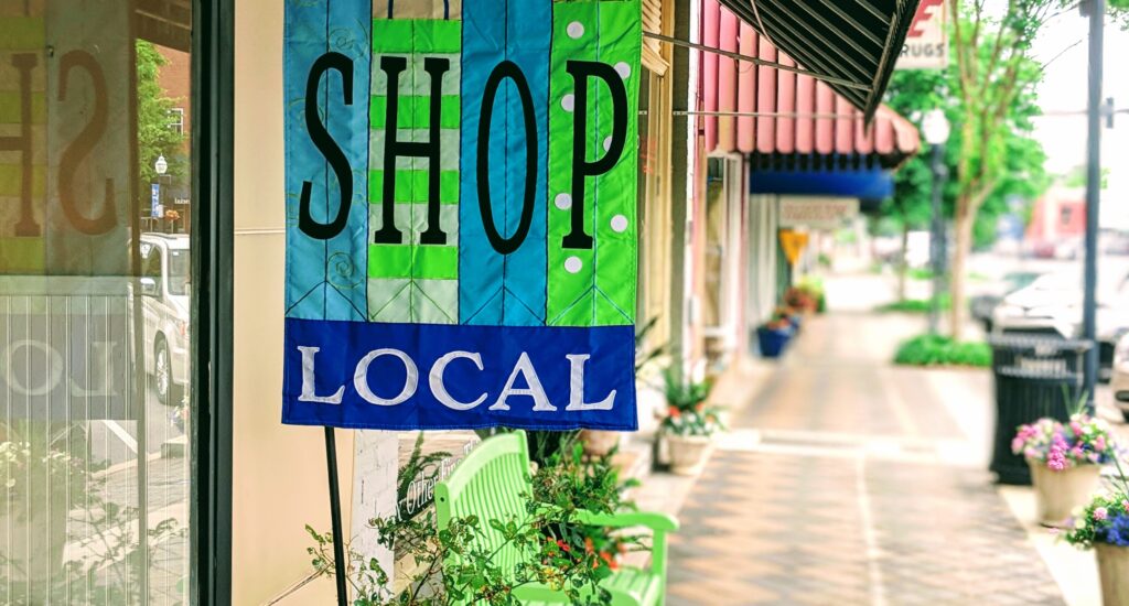 blue and green shop local flag on street scene